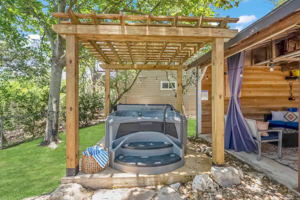 Covered hot tub in the private backyard